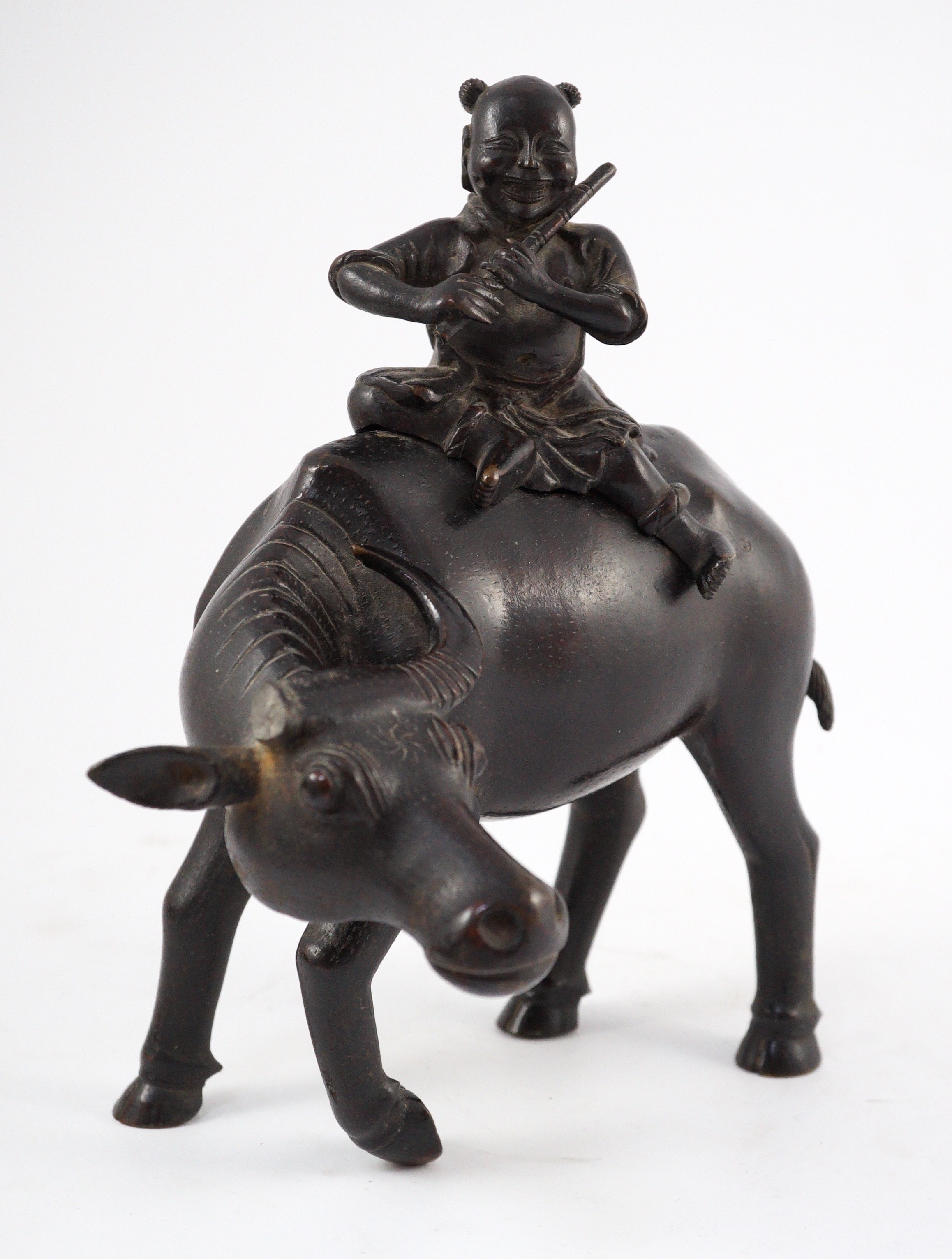 A Chinese bronze ‘boy riding a water buffalo’ censer, 17th/18th century, 22.5cm long, one horn detached but present